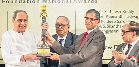 Former CJI NV Ramana presenting Chief Minister Naveen Patnaik with the Lifetime Achievement award in New Delhi on Sunday. (Photo | Express)