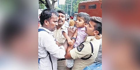 A boy cries as a cop tries to separate him from his father during teachers’ protest | RVK Rao