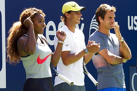 Serena Williams, Rafael Nadal and Roger Federer, right, cheer on the competition during Arthur Ashe Kids' Day, the kick-off to the US Open tennis tournament, Aug 24, 2013, in New York. (File Photo | A