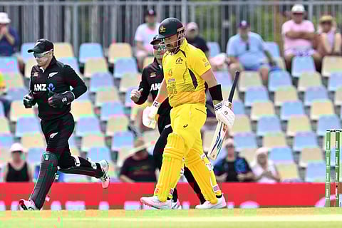 Australia's Aaron Finch (C) walks back to the pavilion after his dismissal during the second one-day international (ODI) cricket match between Australia and New Zealand at the Cazalys Stadium in Cairn