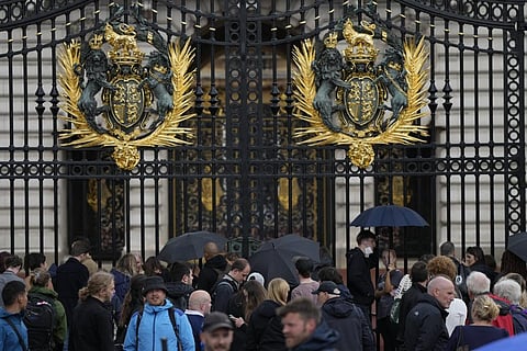 People gather outside Buckingham Palace in London, Thursday, Sept. 8, 2022 after information that Queen Elizabeth II has been placed under medical supervision. (Photo | AP)