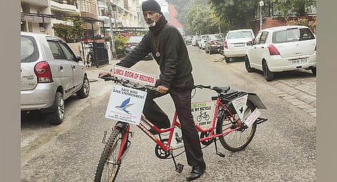 'Birdman' Prince Mehra on his 'bird ambulance', a bicycle, which he uses to look after the injured birds. (Photo | PTI)