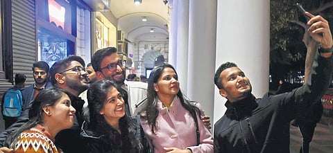 People enjoy an evening out to welcome the New Year at Connaught Place in New Delhi on Saturday | Shekhar Yadav