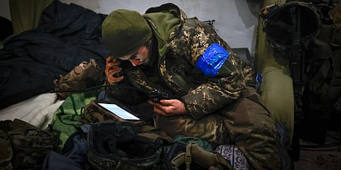 A Ukrainian officer examines the situation in a shelter in Soledar, the site of heavy battles with Russian forces in the Donetsk region. (Photo | AP)