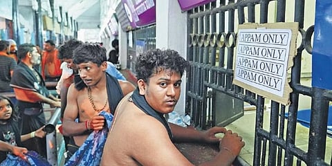 A devotee in front of appam and aravana counter in Sabarimala on Wednesday. TDB said the new cardamom-free batch will be made available from Thursday | Express