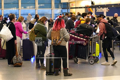 Passengers check in at Chicago's Midway Airport as a computer outage has brought flights to a standstill across the U.S. (Photo | AP)