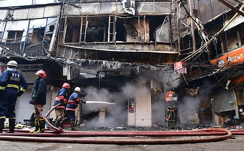 Fire officials trying to douse fire at Bhagirath Palace market of Chandni Chowk where a fire broke out on Nov. 25, 2022. (Photo | Shekhar Yadav, EPS)