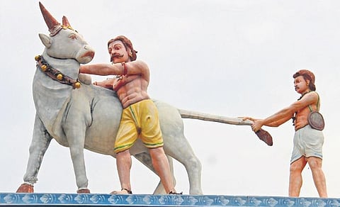 The statue of Alagu Thevar and Samayan on the arch of the temple | kk sundar