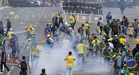 Protesters, supporters of former President Jair Bolsonaro, clash with police during a protest outside the Planalto Palace building in Brasilia, Brazil. (Photo | AP)
