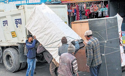 People shift with their belongings in Joshimath on Friday | PTI