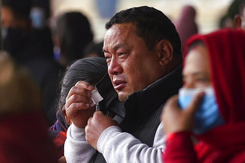 A man cries as he waits to receive the body of a victim of a plane crash, at a hospital in Pokhara, Nepal | AP