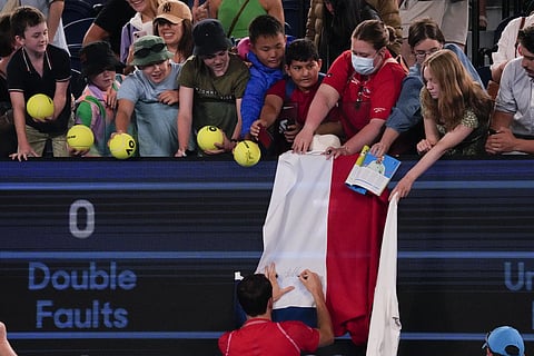 Daniil Medvedev of Russia autographs a Russian flag (Photo | AP)