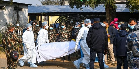 Nepal's army and volunteers carry the body of a victim who died in a plane crash in Pokhara on January 17, 2023. (Photo | AFP)