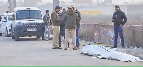 Police inspect a drain where body parts of a man were found in north Delhi
