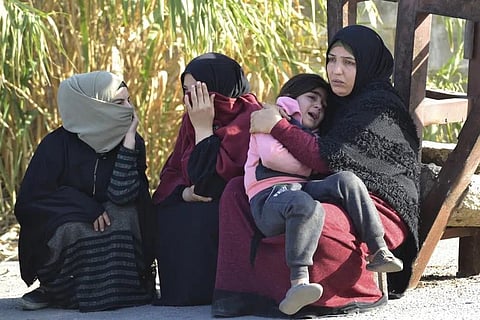 Syrian women relatives of migrants who were rescued by the Lebanese navy wait their relatives to be released outside a navy base, in Tripoli, north Lebanon, Sunday, Jan.1, 2023. (Photo | AP)