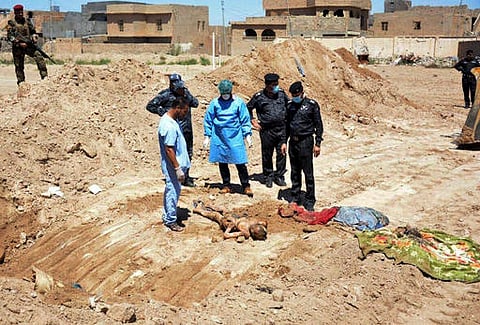 This image released by the the Mass Graves Directorate of the Kurdish Regional Government shows a human jaw bone exhumed from a mass grave containing Yazidis killed by Islamic State militants in the S