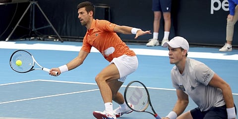 Serbia's Novak Djokovic with Canada's Vasek Pospisil plays a return shot during their doubles match.(Photo | AP)