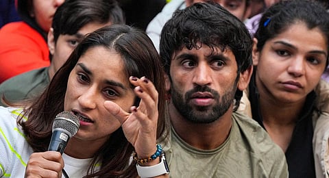 Wrestlers Vinesh Phogat, Bajrang Punia and Sakshi Malik address a press conference after a meeting with officials of Union Sports Ministry regarding their protest. (Photo | PTI)