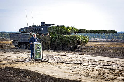German Chancellor Olaf Scholz speaks to soldiers in front of a Leopard 2 main battle tank after the Army's training and instruction exercise in Ostenholz, Germany. (Photo | AP)