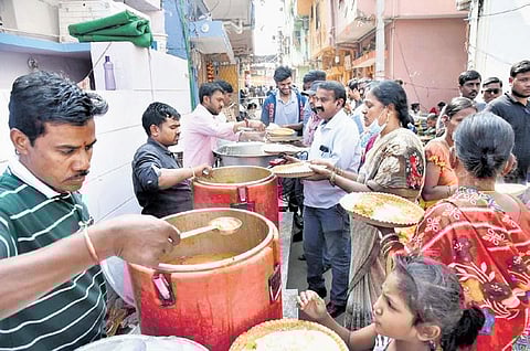 Volunteers serve food to the residents of Nallagutta who vacated their houses after the fire accident at the Deccan Knitwear Sports Accessories building | RVK Rao