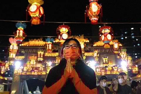 A woman wearing a face mask offers prayer at the Wong Tai Sin Temple, Saturday, Jan. 21, 2023, in Hong Kong, to celebrate the Lunar New Year. (Photo | AP)