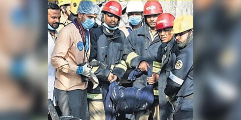 Fire officials and NDRF Teams carry the mortal remains of one of the three missing persons from the fire-ravaged Deccan Knitwear Sports Accessories complex in Nallagutta. 