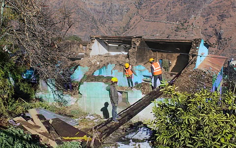 Workers demolish a building in the land subsidence-affected area in Joshimath, Saturday, January 21, 2023. (Photo | PTI)