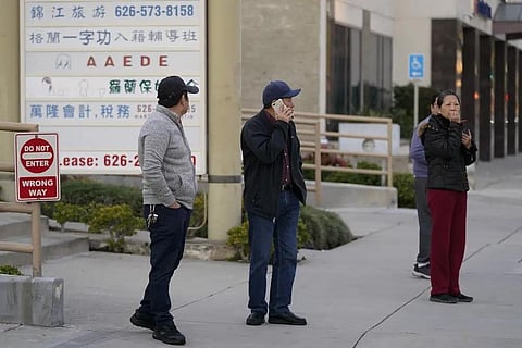 Several residents react as they stand near a ballroom dance club in Monterey Park, Calif., Sunday, Jan. 22, 2023. (Photo | AP)
