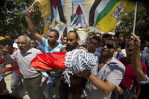 Palestinians carry the body of 18-month-old boy in the West Bank village of Duma, July 31, 2015. The sleeping toddler was burned to death by Jewish assailants. (File Photo | AP)