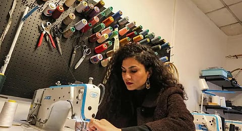 Alaa Adel, an Iraqi fashion designer, works at her 'Iraqcouture' studio in the capital Baghdad, on January 11, 2023. (Photo | AFP)