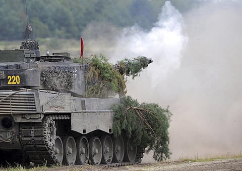 A Leopard 2A6 tank from the Bundeswehr's Panzer exercise bataillon 93 fires at the Oberlausitz training area in Weisskeissel, Germany, Aug. 12, 2009. (File Photo | AP)