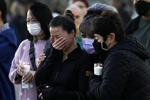 People attend a vigil outside Monterey Park City Hall, blocks from the Star Ballroom Dance Studio on Tuesday, Jan. 24, 2023, in Monterey Park, Calif. (Photo | AP)