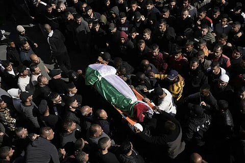Mourners carry the body of a Palestinian woman, identified as Magda Obaid, 60, during her funeral in the West Bank city of Jenin, Thursday, Jan. 26, 2023. (Photo | AP)