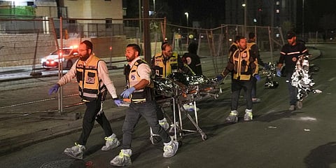 Members of Zaka Rescue and Recovery team evacuate a body after a shooting attack near a synagogue in Jerusalem. (Photo | AP)