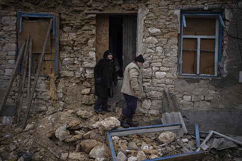 Oleksandra Hryhoryna, (L), inspects her house which was damaged by shelling last fall in Kalynivske, Ukraine, Jan. 28, 2023. (Photo | AP)