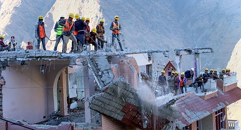 SDRF personnel demolish the Malari Inn hotel, which was marked unsafe in the land subsidence affected area, in Joshimath. (Photo | PTI)