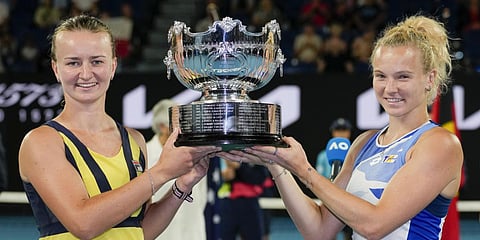 Barbora Krejcikova, left, and Katerina Siniakova hold their trophy aloft after defeating Japan's Shuko Aoyama and Ena Shibahara in the women's doubles final at the Australian Open.(Photo | AP)