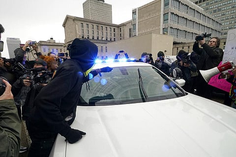 Protesters march in front of a police car Saturday, Jan. 28, 2023, in Memphis, Tenn., over the death of Tyre Nichols, who died after being beaten by Memphis police. (Photo | AP)