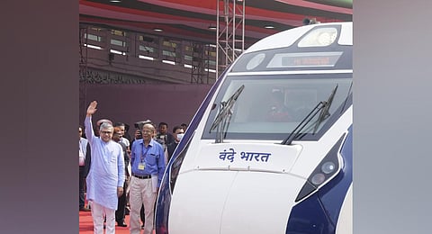 Railways Minister Ashwini Vaishnaw stands near Vande Bharat Express train before its flagging off ceremony, at Howrah railway station in Kolkata. (Photo | PTI)