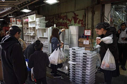 People buy disposable plastic dishes at Mahane Yehuda market in Jerusalem, Friday, Jan. 20, 2023. (Photo | AP)