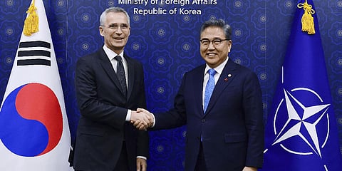 NATO Secretary-General Jens Stoltenberg, left, shakes hands with South Korean Foreign Minister Park Jin.(Photo | AP)
