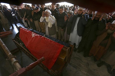 People attend the funeral prayer for a police officer killed in Monday's suicide bombing inside a mosque in Peshawar, Pakistan. (Photo | AP)