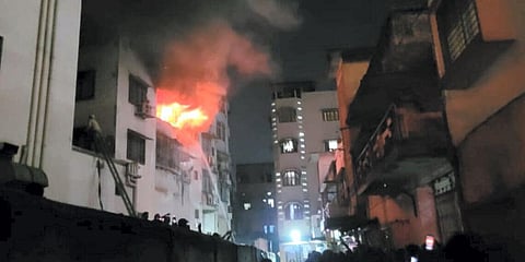 Firefighters try to douse a fire that broke out at, multi-storey building in Dhanbad. (Photo | PTI)