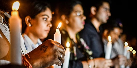 In this backdated image, members of India's Youth Congress take part in a candlelight march to pay tribute to the victims who died in the Morbi bridge collapse. (File Photo | PTI)