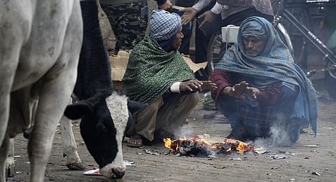 People warm themselves near a bonfire during a cold winter morning, in New Delhi, Wednesday, Jan 4, 2023. (Photo | PTI)