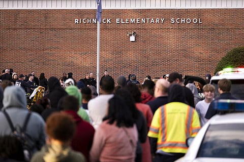 Students and police gather outside of Richneck Elementary School after a shooting, Friday. (Photo | AP)