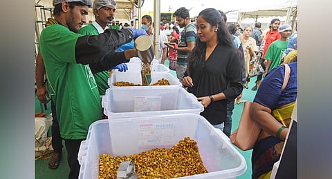 People buy their favourite snack at a stall in Avarebele Mela on National College Grounds on Friday | Vinod kumar T