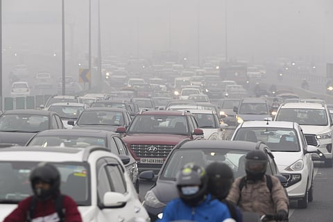Vehicles ply on a road amid low visibility due to a thick layer of fog on a cold winter morning, in New Delhi. (Photo | PTI)