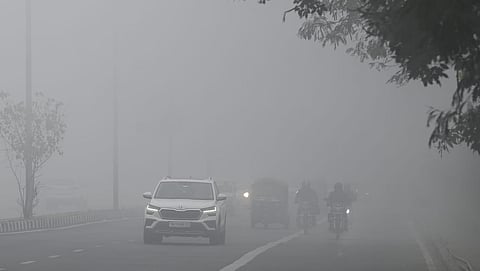 Vehicles ply on a road amid low visibility due to a thick layer of fog on a cold winter morning, in New Delhi. (Photo | Shekhar Yadav, EPS)