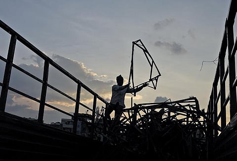 A man is seen collecting leftover iron material taken from immersed Ganesh idols at People’s Plaza, Hyderabad on Saturday | Sri Loganathan Velmurugan